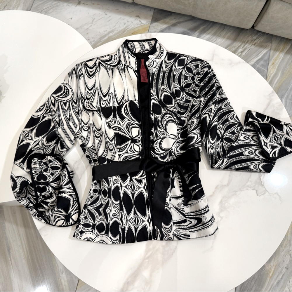 Black and white patten stylish blouse paired with a black ribbon